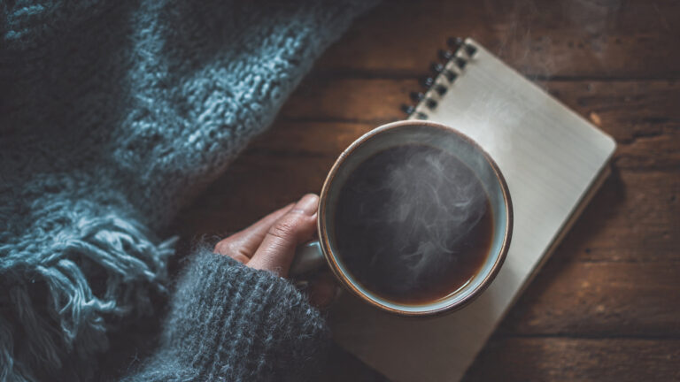 A-hand-holding-a-cup-of-steaming-coffee-or-tea-nea (2)